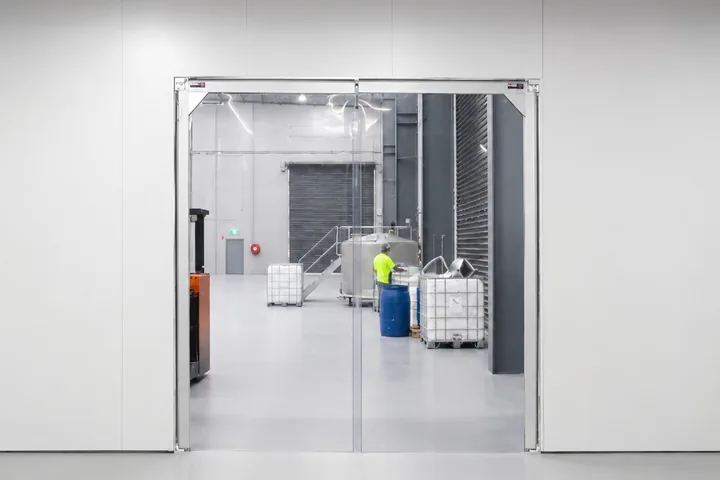 Flexible PVC swing doors in an industrial corridor